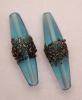 Oliva lunga, 38x12 mm., Indicolite con bronzo filigranato Oliva lunga, 38x12 mm., Indicolite con bronzo filigranato